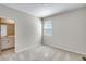 Neutral bedroom featuring a window and an attached bathroom with tiled floors and a vanity at 1443 Great Western Dr, Longmont, CO 80501