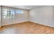 Bright bedroom featuring hardwood floors, neutral walls, and large windows offering natural light and neighborhood views at 1443 Great Western Dr, Longmont, CO 80501