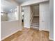Inviting entryway boasts hardwood floors, staircase, and open layout to the kitchen at 1443 Great Western Dr, Longmont, CO 80501