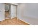 Welcoming entryway showcases wood floors, a carpeted staircase, and white interior door at 1443 Great Western Dr, Longmont, CO 80501