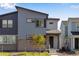 A modern two-story home featuring a stylish gray exterior, well-maintained lawn, and inviting front entrance at 1443 Great Western Dr, Longmont, CO 80501