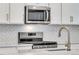 Close-up of the kitchen area with stainless steel appliances and quartz countertops at 1443 Great Western Dr, Longmont, CO 80501