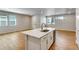 Well-lit kitchen with a quartz island, stainless steel appliances, and wood floors at 1443 Great Western Dr, Longmont, CO 80501