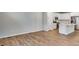 Open living area with wood floors leading to a kitchen with stainless steel appliances and white cabinetry at 1443 Great Western Dr, Longmont, CO 80501