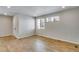 Open living room with hardwood floors, recessed lights, and large windows providing ample natural light at 1443 Great Western Dr, Longmont, CO 80501