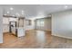 Bright, open floor plan with wood floors connecting the living area and kitchen with stainless appliances at 1443 Great Western Dr, Longmont, CO 80501