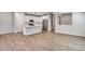 Bright, open living area with wood floors, white kitchen, and stainless steel appliances at 1443 Great Western Dr, Longmont, CO 80501