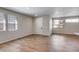 Spacious living room with hardwood floors, neutral walls, and bright windows offering plenty of natural light at 1443 Great Western Dr, Longmont, CO 80501