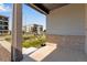 View from the covered front porch of a home showcasing landscaping and surrounding apartment buildings at 1443 Great Western Dr, Longmont, CO 80501