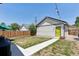 Spacious backyard with a cement walkway, well-kept lawn, a wooden fence and green accents at 4080 Adams St, Denver, CO 80216