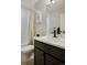 Bright bathroom featuring a shower with white tiling, sleek vanity, and modern fixtures at 4080 Adams St, Denver, CO 80216