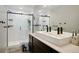 Modern bathroom features a walk-in shower with white subway tile and dark fixtures and hardware at 4080 Adams St, Denver, CO 80216
