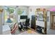 Bedroom with bright windows, home office setup and decorative gold shelving at 4080 Adams St, Denver, CO 80216