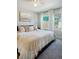 Cozy bedroom with a plush bed, decorative pillows, and an abundance of natural light from the large windows at 4080 Adams St, Denver, CO 80216