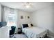 Bright, modern bedroom with a desk, modern art, and a large window with white curtains at 4080 Adams St, Denver, CO 80216