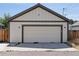 Detached garage featuring a clean white door, modern exterior, and well-kept lawn at 4080 Adams St, Denver, CO 80216