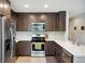 Modern kitchen features stainless steel appliances, dark wood cabinets, and light countertops at 4080 Adams St, Denver, CO 80216