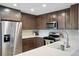 Modern kitchen features stainless steel appliances, white countertops, and sleek, dark wood cabinetry at 4080 Adams St, Denver, CO 80216