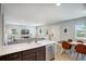 Open concept living area with a dining area adjacent to the kitchen island and a living room with lots of natural light at 4080 Adams St, Denver, CO 80216