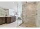 Sleek bathroom featuring a dark wood vanity, glass-enclosed shower with white tile, and modern fixtures at 474 S Gaylord St, Denver, CO 80209