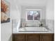 Modern bathroom featuring a large soaking tub with white marble tile and a wood-paneled base at 474 S Gaylord St, Denver, CO 80209