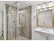 Bathroom featuring walk-in shower with glass door and a pedestal sink with ornate mirror at 474 S Gaylord St, Denver, CO 80209
