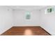 Basement bedroom featuring laminate wood floors, baseboard heating and a large window at 474 S Gaylord St, Denver, CO 80209