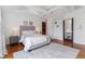 Well-lit bedroom with vaulted ceilings, hardwood floors, a sliding glass door, and a large decorative rug at 474 S Gaylord St, Denver, CO 80209
