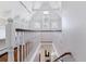 Upstairs hallway showcasing bright white walls and railings, as well as hardwood floors at 474 S Gaylord St, Denver, CO 80209