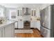 Modern kitchen with white cabinetry, subway tile backsplash, and stainless steel appliances, offering a clean aesthetic at 474 S Gaylord St, Denver, CO 80209