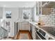 Contemporary kitchen with white cabinetry, subway tile backsplash, and stainless steel appliances, perfect for cooking at 474 S Gaylord St, Denver, CO 80209