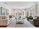 Bright living room with large windows, hardwood floors and neutral decor, creating a serene atmosphere at 474 S Gaylord St, Denver, CO 80209