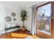 Cozy sitting area with bench, tree, and curtains adjacent to door with access to outdoor balcony at 474 S Gaylord St, Denver, CO 80209