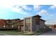 Modern home with brick and wood accents, balcony, and well-maintained lawn at 1016 24Th St, Golden, CO 80401