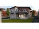 Backyard view of a two-story modern home with a balcony and outdoor seating on the ground level at 1016 24Th St, Golden, CO 80401