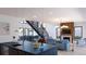 Bright, open-concept living space with fireplace and modern staircase features hardwood floors at 1016 24Th St, Golden, CO 80401