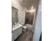 Bathroom featuring a modern vanity, tub/shower combination with elegant tile work, and contemporary fixtures at 8163 S Valleyhead Way, Aurora, CO 80016