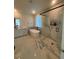 Modern bathroom features a freestanding tub, large glass shower, stylish fixtures, and neutral colors at 8163 S Valleyhead Way, Aurora, CO 80016