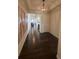 Inviting entry featuring hardwood floors, elegant lighting, decorative wall art, and views of other rooms at 8163 S Valleyhead Way, Aurora, CO 80016
