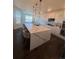 Bright, modern kitchen with a spacious island, stylish bar stools, pendant lighting, and modern appliances at 8163 S Valleyhead Way, Aurora, CO 80016