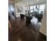 Bright, open living area with hardwood floors, large windows, and modern decor with a plant adding a natural touch at 8163 S Valleyhead Way, Aurora, CO 80016