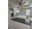 Serene main bedroom features a tray ceiling with fan, ample natural light, and a stylish ensuite bathroom entrance at 8163 S Valleyhead Way, Aurora, CO 80016