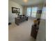 Well-lit office space featuring a large window, a desk, and neutral carpeting at 8163 S Valleyhead Way, Aurora, CO 80016