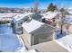 Exterior of house with snow covered yard and mountain views at 9485 Joyce Ln, Highlands Ranch, CO 80126