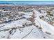 Aerial view of neighborhood with snowy landscape and mountains in the distance at 9485 Joyce Ln, Highlands Ranch, CO 80126