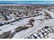 Aerial view of neighborhood with snowy landscape and mountains at 9485 Joyce Ln, Highlands Ranch, CO 80126