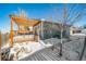 Backyard with pergola, deck, and snowy landscape at 9485 Joyce Ln, Highlands Ranch, CO 80126