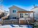 House backyard with deck and pergola covered patio, snow on the ground at 9485 Joyce Ln, Highlands Ranch, CO 80126