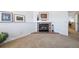 Gathering room with corner brick fireplace and hardwood floors at 9485 Joyce Ln, Highlands Ranch, CO 80126