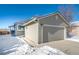 House exterior with attached garage and snowy driveway at 9485 Joyce Ln, Highlands Ranch, CO 80126